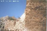 Castillo de las Peuelas. Murallas del castillo y detalle de la saetera del torren rectangular